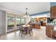 Eat-in kitchen featuring oak cabinets, island with bar seating, and large windows offering expansive views at 7583 W Trail South Dr, Littleton, CO 80125