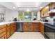Functional kitchen featuring classic cabinetry, ample counter space, and a bright window overlooking the backyard at 7583 W Trail South Dr, Littleton, CO 80125