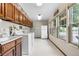 Functional laundry room with ample storage cabinets and large windows for natural light at 7583 W Trail South Dr, Littleton, CO 80125