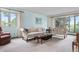 Comfortable living room with large windows, offering natural light and views of the surrounding greenery at 7583 W Trail South Dr, Littleton, CO 80125