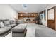 Cozy living room with a brick fireplace, a skylight, and comfortable seating at 7583 W Trail South Dr, Littleton, CO 80125
