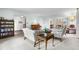 Bright living room featuring classic furniture, a piano, and seamless flow into the dining area at 7583 W Trail South Dr, Littleton, CO 80125
