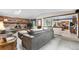 Comfortable living room with brick fireplace extending into the adjacent eat-in kitchen at 7583 W Trail South Dr, Littleton, CO 80125