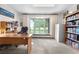 Bright office with a bay window, built-in bookshelves, and a comfortable workspace at 7583 W Trail South Dr, Littleton, CO 80125