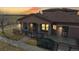 Beautiful exterior view of the home featuring warm stucco siding, a covered porch and a dark roof at 15501 E 112Th Ave # 30A, Commerce City, CO 80022