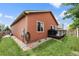 Landscaped backyard with small deck, green lawn, and charming curb appeal offers a serene outdoor space at 1836 Taos St, Brighton, CO 80603
