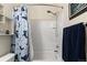 Bathroom with a tiled shower and tub with a blue shower curtain at 1836 Taos St, Brighton, CO 80603