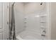 Bathroom featuring a tiled shower and tub with a white shower curtain at 1836 Taos St, Brighton, CO 80603