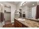 Bathroom featuring laminate flooring, a walk in closet, and a granite countertop vanity at 1836 Taos St, Brighton, CO 80603