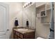 Bathroom with a vanity with a sink, granite countertops, and a shower with blue accents at 1836 Taos St, Brighton, CO 80603
