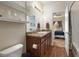 Bathroom featuring a granite countertop vanity, laminate flooring, and a view into the bedroom at 1836 Taos St, Brighton, CO 80603