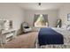 Comfortable bedroom featuring a vanity, accent chair, neutral carpet, and bright natural lighting at 1836 Taos St, Brighton, CO 80603