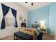 bedroom with a bright blue accent wall, carpet, and a large window at 1836 Taos St, Brighton, CO 80603