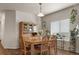Dining area showcasing wooden table with seating and hutch against a window at 1836 Taos St, Brighton, CO 80603