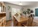 Bright dining room with wood floors, large window, and charming botanical accents at 1836 Taos St, Brighton, CO 80603