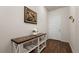 Inviting entryway with beautiful wood floors and a stylish console table with decor at 1836 Taos St, Brighton, CO 80603