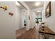 Bright hallway featuring lovely wood floors leading to the main living spaces at 1836 Taos St, Brighton, CO 80603