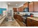 Charming kitchen featuring stainless steel appliances, wooden cabinetry and stone countertops at 1836 Taos St, Brighton, CO 80603