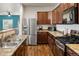 Well-equipped kitchen with stainless steel appliances, beautiful cabinetry, and seamless open floor plan at 1836 Taos St, Brighton, CO 80603