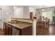 Open-concept kitchen with stainless steel appliances, granite counters, and adjacent dining area at 1836 Taos St, Brighton, CO 80603