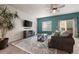 Cozy living room features a decorative rug, comfortable seating, and a modern entertainment center at 1836 Taos St, Brighton, CO 80603