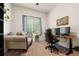 Well-lit home office featuring a sofa, desk with dual monitors, and neutral carpet at 1836 Taos St, Brighton, CO 80603