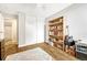 Bedroom with wood shelving, guitar, and view of bathroom at 2231 S Vaughn Way # 305B, Aurora, CO 80014
