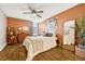 Main bedroom with orange accent wall and ceiling fan at 2231 S Vaughn Way # 305B, Aurora, CO 80014
