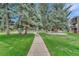 Pathway to community pool, surrounded by lush green grass at 2231 S Vaughn Way # 305B, Aurora, CO 80014
