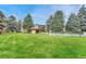 Community pool and grassy area with trees and building view at 2231 S Vaughn Way # 305B, Aurora, CO 80014