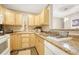 Galley kitchen with light wood cabinets at 2231 S Vaughn Way # 305B, Aurora, CO 80014