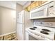 White appliances and wood cabinets in kitchen at 2231 S Vaughn Way # 305B, Aurora, CO 80014