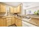 Galley kitchen with light wood cabinets at 2231 S Vaughn Way # 305B, Aurora, CO 80014