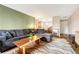 Spacious living room with L-shaped sectional sofa and wood coffee table at 2231 S Vaughn Way # 305B, Aurora, CO 80014