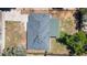 A bird's eye view of a single Gathering home showcasing the dark roof, green back patio roof and surrounding trees at 1179 Salem St, Aurora, CO 80011