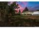 Lovely backyard featuring a long patio with dark support columns at dusk at 1179 Salem St, Aurora, CO 80011