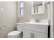 Bathroom featuring modern fixtures and a toilet near a vanity and well lit mirror at 1179 Salem St, Aurora, CO 80011