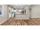 Well-designed kitchen flows into the living area with white cabinets, stainless appliances and a breakfast bar at 1179 Salem St, Aurora, CO 80011