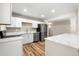 Well-lit kitchen with stainless steel appliances and sleek countertops with wood flooring at 1179 Salem St, Aurora, CO 80011