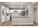 Modern kitchen with white cabinets, stainless steel appliances, marble countertops and open layout at 1179 Salem St, Aurora, CO 80011