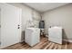 Functional laundry area with washer, dryer, and durable wood-look flooring at 1179 Salem St, Aurora, CO 80011
