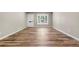 Inviting living room with new floors, fresh paint, large front window and a white entry door at 1179 Salem St, Aurora, CO 80011