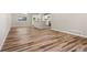 Open-concept living space with hardwood floors, neutral paint, and bright kitchen area at 1179 Salem St, Aurora, CO 80011