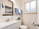 Well-lit bathroom featuring a sleek vanity, modern fixtures, and a shower with stylish tile accents at 2986 S Elm St, Denver, CO 80222