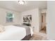 Bright bedroom featuring a comfortable bed, stylish decor, and a glimpse into the hallway at 2986 S Elm St, Denver, CO 80222