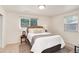 Serene bedroom with a plush bed, neutral color scheme, and natural light from two windows at 2986 S Elm St, Denver, CO 80222