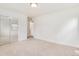 Bedroom with carpet, closet with sliding mirrored doors at 2986 S Elm St, Denver, CO 80222