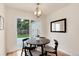 Contemporary dining area with backyard view and modern lighting at 2986 S Elm St, Denver, CO 80222