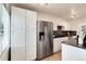 Modern kitchen with stainless steel refrigerator and matching appliances, bright cabinets and counters at 2986 S Elm St, Denver, CO 80222