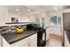 Well-lit kitchen featuring a gas range and bar seating at 2986 S Elm St, Denver, CO 80222